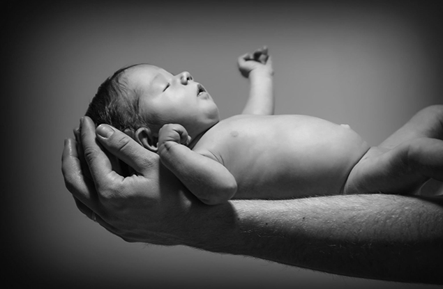 Adorable Little Baby Girl on her father's Hands