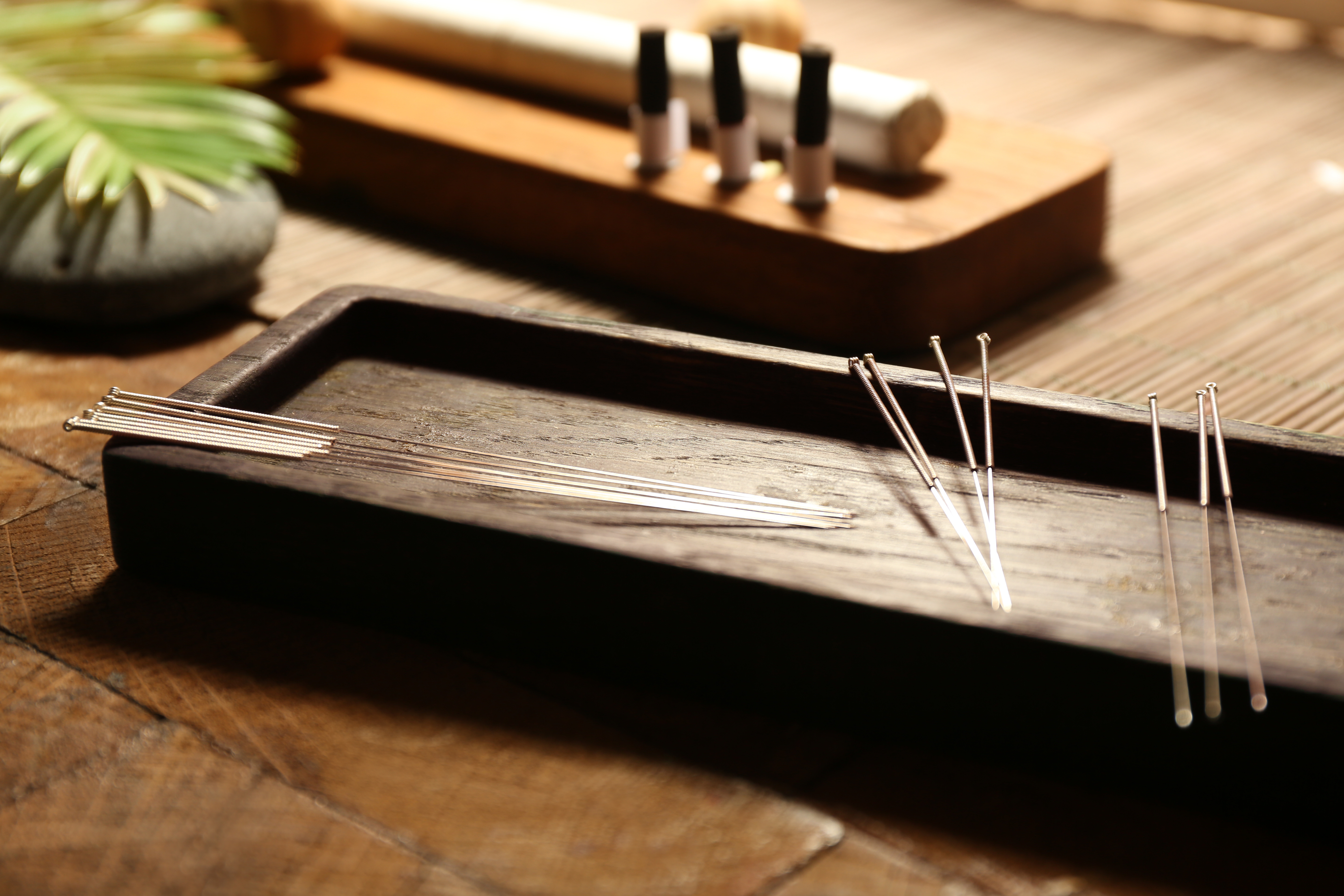 Acupuncture needles on wooden table